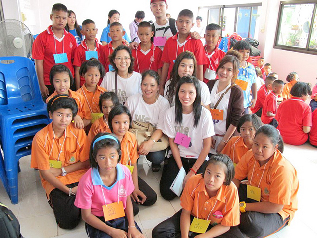 volunteers and students smiling to the camera