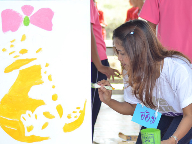 A volunteer drawing on the wall