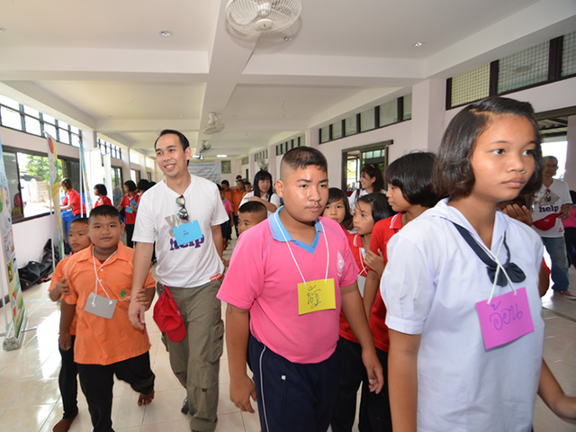 Volunteers and students walking in the hallway